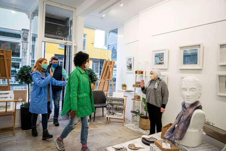 Customers with Covid-19 masks walking into shop